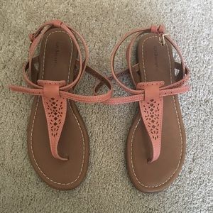 Pink leather t-strap sandals.